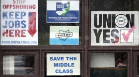 In this Nov. 27, 2018 photo, signs hang from windows at the UAW Local 1112 union hall, in Lordstown, Ohio. (Tony Dejak/AP)