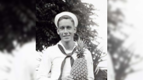 Joseph-Hoffman in uniform holding a pineapple