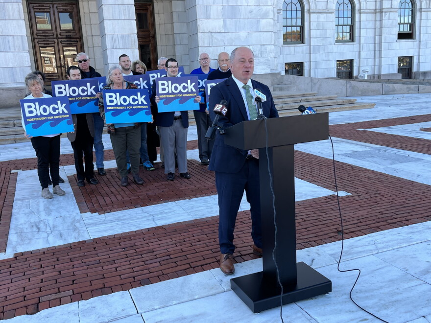 Independent gubernatorial candidate Ken Block speaks at a news conference outside the Rhode Island State House in Providence on Monday, Oct. 26, 2026, as supporters stand behind him. Block outlined 17 policy priorities and pledged not to undermine the Affordable Care Act if elected governor. Credit: Ian Donnis/Ocean State Media