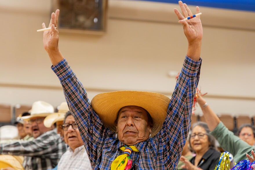 A Handgame participant holds up bones for all players to see on July 17, 2024.