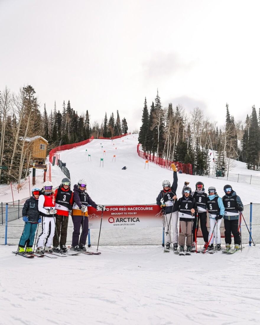 Skiers in front of the Shred for Red racecourse
