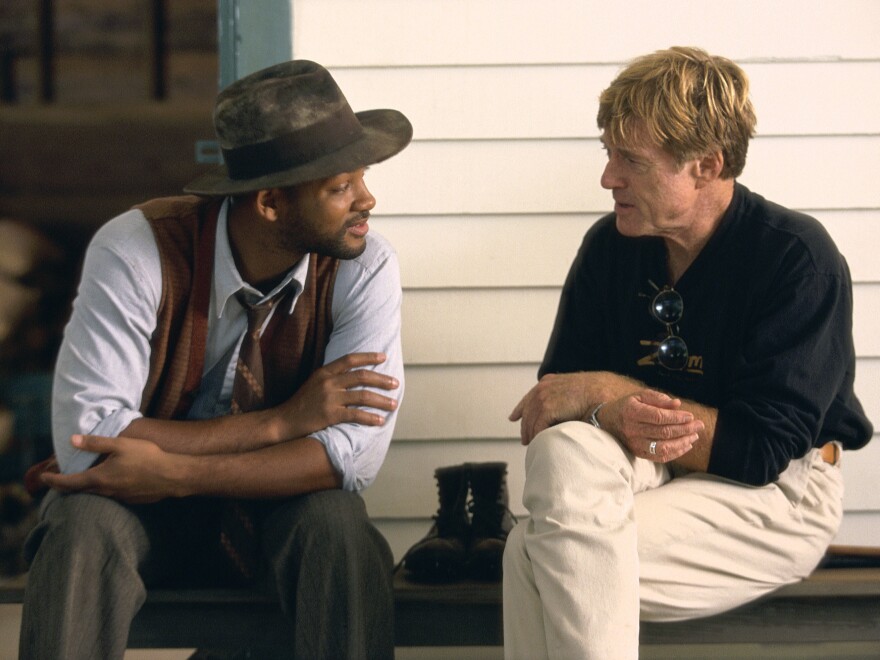 Will Smith talks to Robert Redford on the set of The Legend Of Bagger Vance, which Redford directed, in 2000.