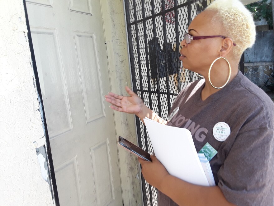 Alecia Tramel goes door-to-door getting out the word about Amendment 4 in Miami. 