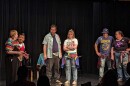 Capital City Improv Members stand on stage in an improvised scene.