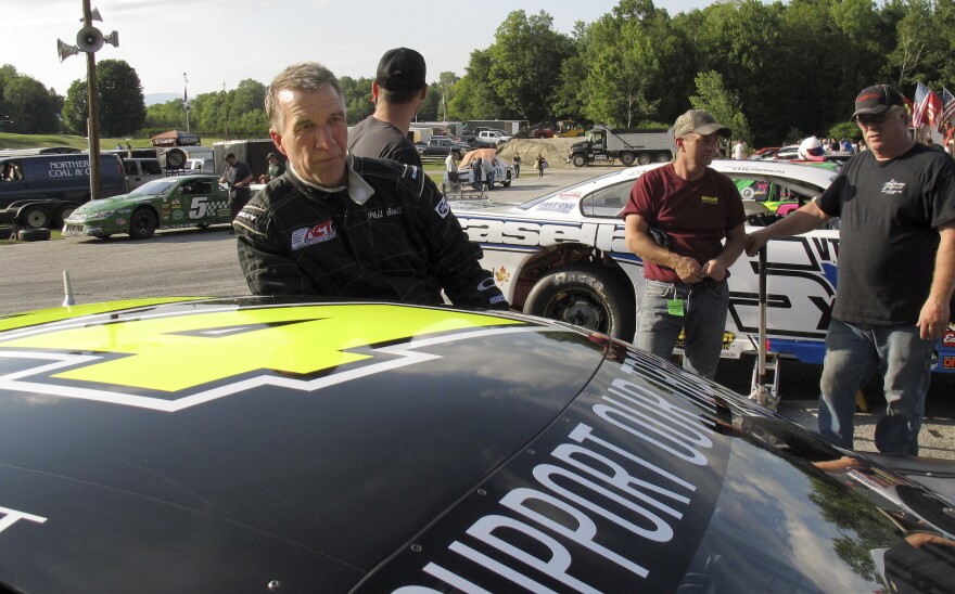 Gov. Phil Scott stands near his 14 car at Thunder Road.