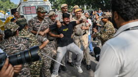 Police officers detain a protester during a demonstration on Oct. 10, 2026 in New Delhi, India. The Cockroach Janta Party (CJP) has called a mass protest to demand the resignation of India's Chief Election Commissioner, Gyanesh Kumar, over what they say are alleged irregularities in electoral processes and the revision of voter rolls. (Ritesh Shukla/Getty Images)