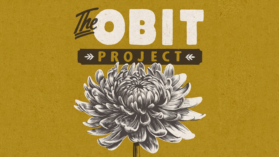 Graphic poster with a mustard yellow background reading “The Obit Project.” The word “The” appears in black script above large white block letters spelling “OBIT.” Below, the word “PROJECT” appears in gold letters inside a black horizontal banner with small decorative arrows on each side. A detailed black-and-white illustration of a large chrysanthemum flower fills the lower half of the design.