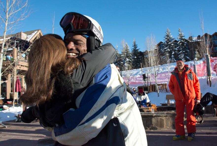 Todd Hood of Long Beach, Calif., reunites with his friend Laura James at Black Ski Summit. He and Jerry Elie (right) of Akron, Ohio, were relaxing by the fire pit after skiing when they spotted Laura.