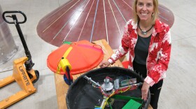 Belinda Batten of Oregon State University stands in front of a wave energy generator prototype.