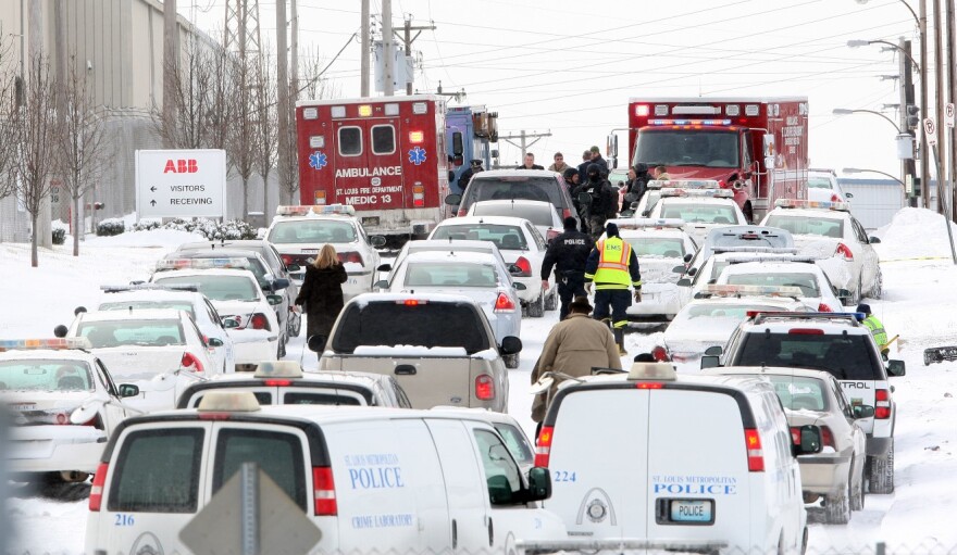 Dozens of law enforcement vehicles line Bircher Boulevard, outside ABB's complex in north St. Louis, on Jan. 7, 2010.