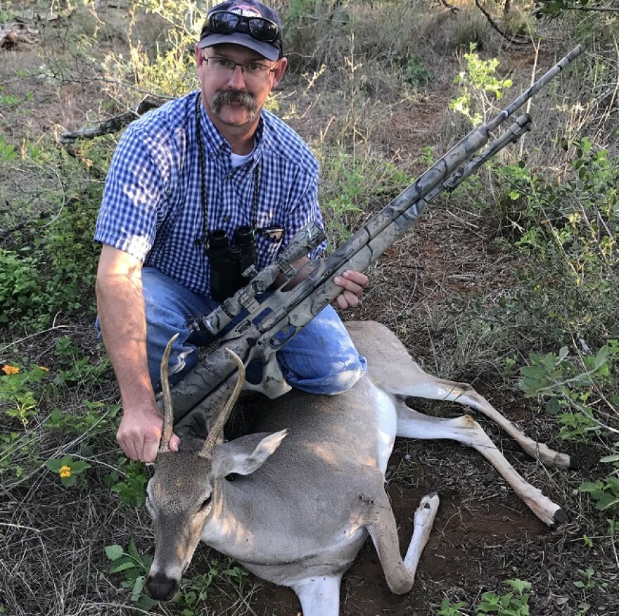 Alan Cain, Texas Parks & Wildlife Department Whitetail Deer program leader, with a spike buck he took with Airforce Texas big bore air rifle