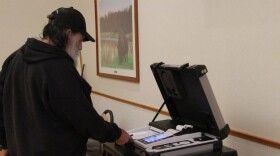 Gary Corn, 74, inserts his ballot into the voting machine during a special election on the adult use of recreational marijuana in Oklahoma, March, 7, 2023, at a Del City Community Center polling station.