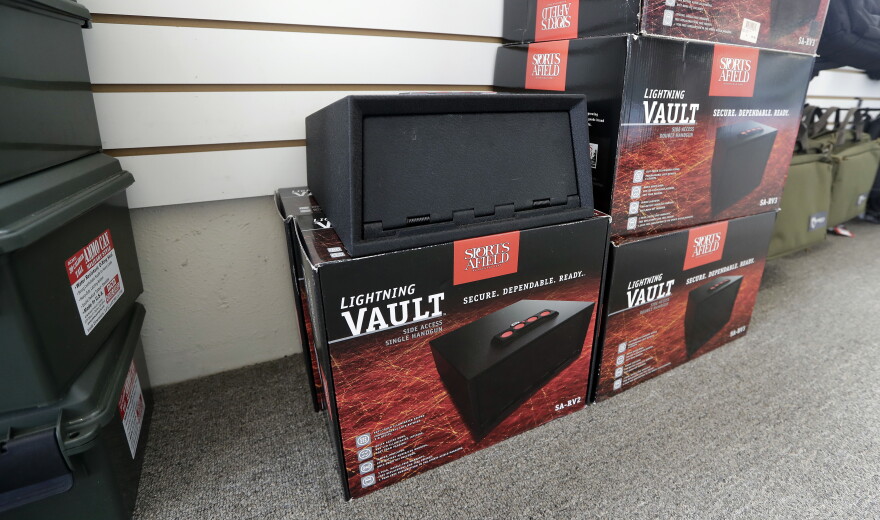 Gun safes sit against a wall at a gun shop.