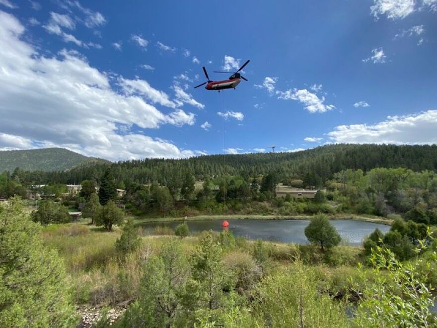 A Chinook Helicopter dips out of Monastery Lake in the West Zone