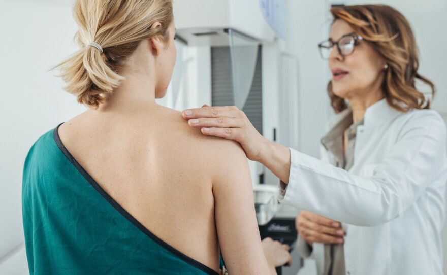 This stock photo shows a female doctor talking to a patient who is there to get a mammogram.