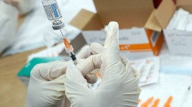 A registered nurse fills a syringe with the Johnson & Johnson COVID-19 vaccine at a pop-up vaccination site in the Staten Island borough of New York, April 8, 2021.