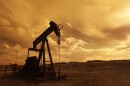 An oil rig silhouetted against the sunset. 