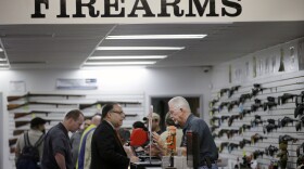  In this Dec. 9, 2015,  photo, sales associate Mike Conway, right, shows Paul Angulo guns at Bullseye Sport gun shop in Riverside, Calif. (Jae C. Hong/AP)