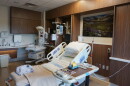 An empty hospital bed in a hospital room.