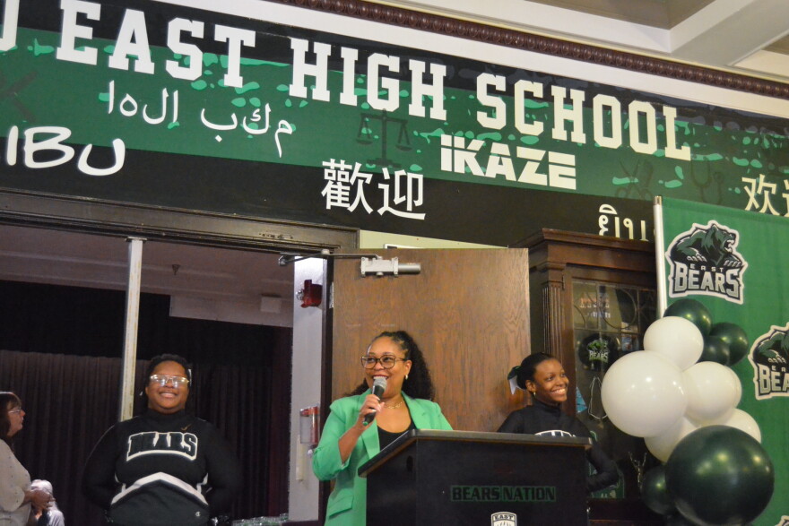 Superintendent Jennifer Collier celebrates East High School's centennial anniversary with a crowd of student, alumni and staff.