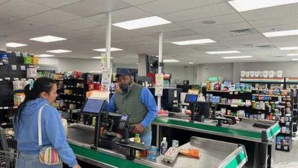 Hameed Bello, co-owner of Farm Store 99 in Downtown Springfield, Ma., serves a customer recently.