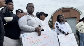 Demonstrators hold handmade signs outside Women Huron Valley correctional facility. One sign reads "Justice For The Women At Huron Valley" and another reads "THEY CAN NOT SPEAK SO WE ARE THEIR VOICE !!!". 