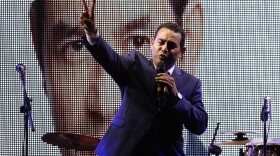 Television comedian and presidential candidate for the National Front of Convergence party Jimmy Morales, flashes a victory sign to his supporters at his party headquarters in Guatemala City, Sunday night. (AP Photo/Luis Soto)