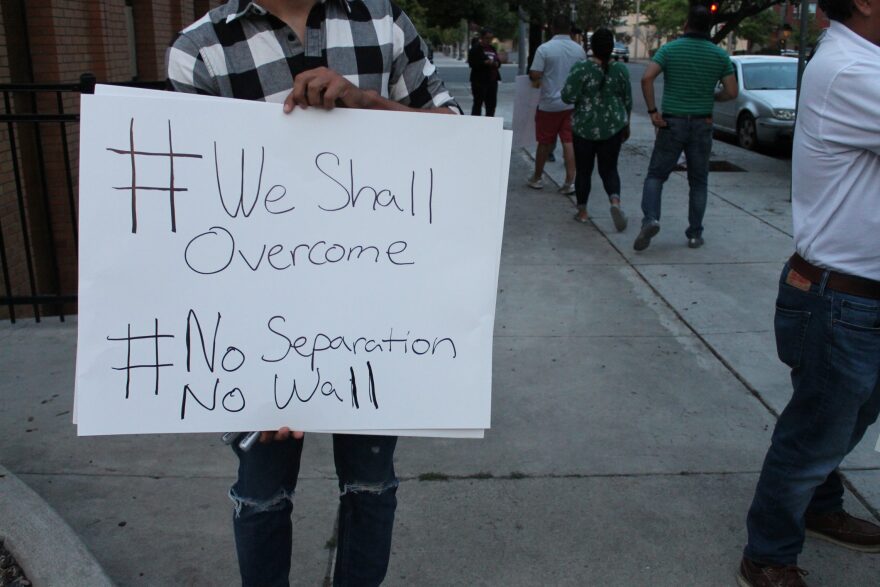 A protester outside the Yakima County Jail Wednesday, June 27 joins several others in calling for the release of detained immigrants. CREDIT: ESMY JIMENEZ/NWPB