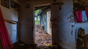 The front door of a destroyed Otake Camp home leads to another that was swept by flood waters. (March 25, 2026)
