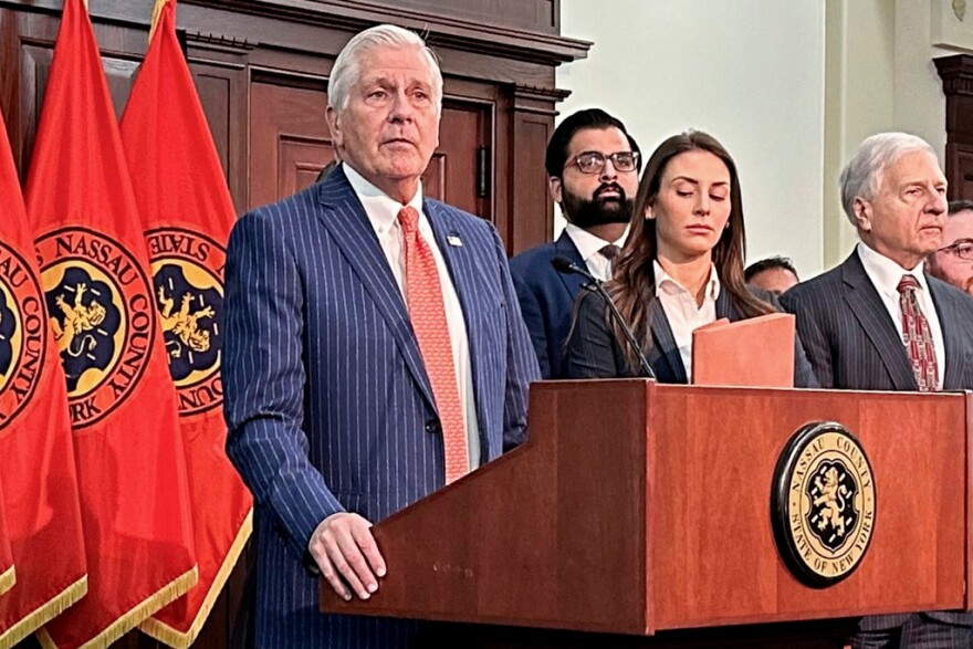 FILE - Nassau County Executive Bruce Blakeman, at podium, speaks during a news conference in Mineola, N.Y., March 6, 2024. (AP Photo/Philip Marcelo, File)