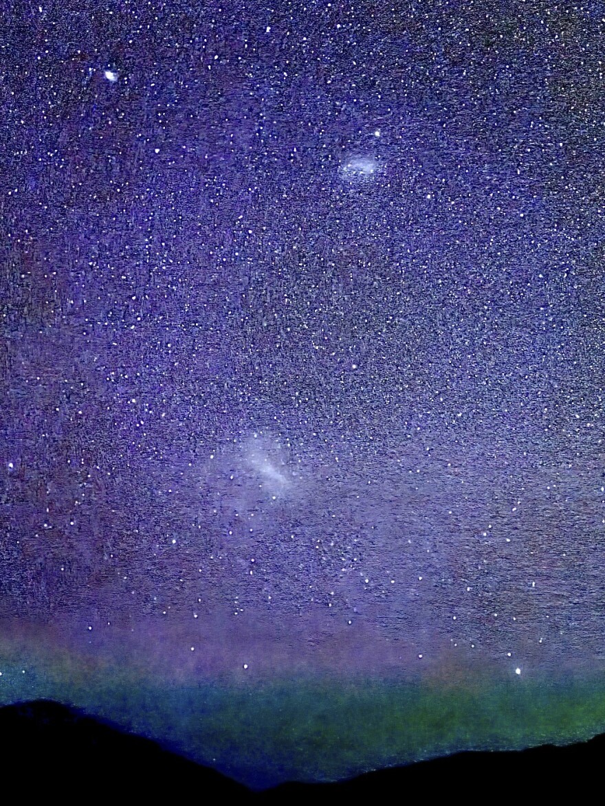 Here, the bright star at top left is Achernar, south of Fomalhaut in our current fall sky. Below it is the SMC, and the blur just above it is the fine globular cluster 47 Tucanae. The bar is full of new blue stars and red stellar nurseries, as the See Star will show soon. Farther south, the obvious bar of the LMC, with a bright “star” directly below the bar that is the Tarantula Nebula, the largest stellar nursery in the Local Group of Galaxies. At the bottom right, in the greenish airglow, is Canopus, the second brightest star in our sky, rising. Only Sirius, 40 degrees north of it in the winter sky, outshines it to our eyes.