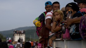 Migrants hitch rides on passing truck as they continue on their journey after Mexican police briefly blockaded the road to keep them from advancing, outside the town of Arriaga, Mexico, Saturday, Oct. 27, 2018. Hundreds of Mexican federal officers carrying plastic shields briefly blocked the caravan of Central American migrants from continuing toward the United States, after several thousand of the migrants turned down the chance to apply for refugee status and obtain a Mexican offer of benefits. (AP Photo/Rebecca Blackwell)