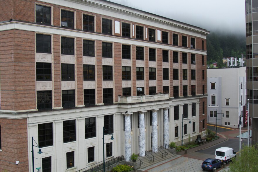 A ochre and white concrete building in a greay cloudy day