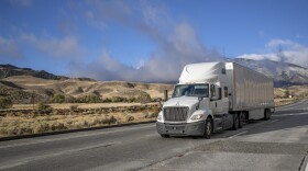 Stock photo of a semi truck driving on a highway.