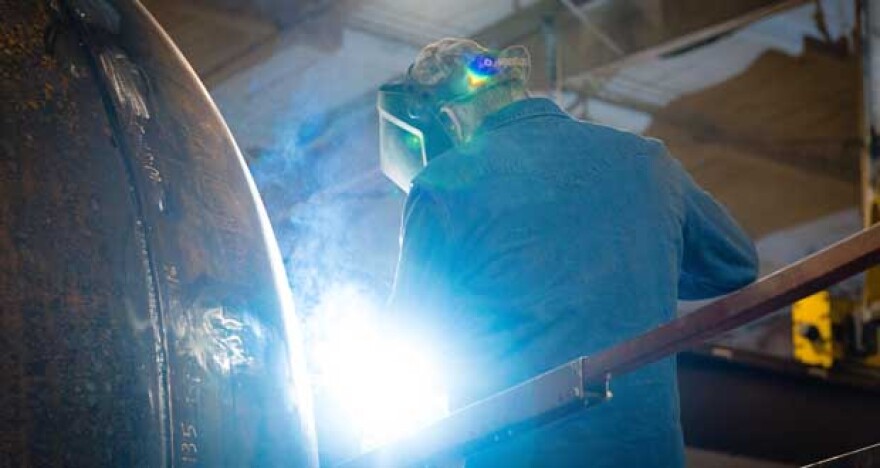 Welders work on separation system tanks inside the Filtra-Systems Co. facility in Marietta.