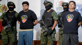 Alleged drug traffickers Christopher Fuentes Letelier (second from left) and Rafael Bautista Delgado (right) are presented to the press in Mexico City on Sept. 9. The two are alleged members of Los Zetas, a notoriously dangerous drug cartel founded by 31 elite Mexican army anti-narcotics commandos.