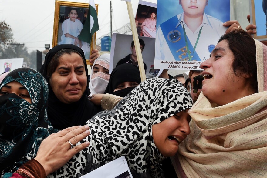 Relatives of more than 100 Pakistani schoolchildren killed in a December 2014 Taliban attack in Peshawar weep during a protest over delays in an investigation of the massacre in February 2015.