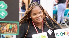 Desmyn Owens, the associate extension agent for 4-H youth development in Virginia Beach, speaks with a parent during the Back-to-School Care Fair on Saturday, Aug. 16, 2025, at the Virginia Beach Convention Center.