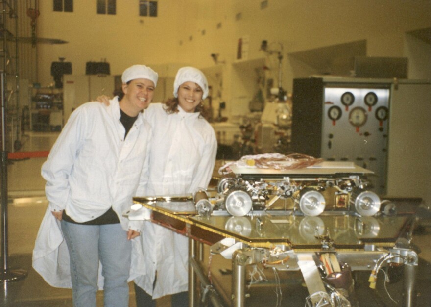 Cindy Healy (right) stands with friend and fellow engineer Becky Manning Mitties in the NASA clean room.