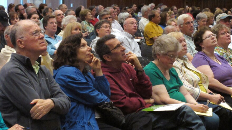 The audience concentrates on a presentation by Kansas Insurance Commissioner Sandy Praeger's office about the federal health care overhaul at the University of Kansas satellite campus in Overland Park, Kan., earlier this month.
