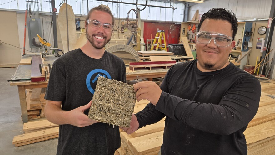 K-State architecture students Mario Castro-Cortes, right, and Joe Winter, left, show a sample of the hempcrete insulation they make with hurd from Prairie Band Ag.