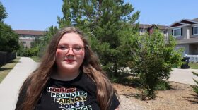 Michaela Ficek, a fair housing specialist for the High Plains Fair Housing Center, is pictured July 24, 2026, near apartment buildings and homes in Bismarck. She is at risk of being furloughed due to a gap in federal funding.