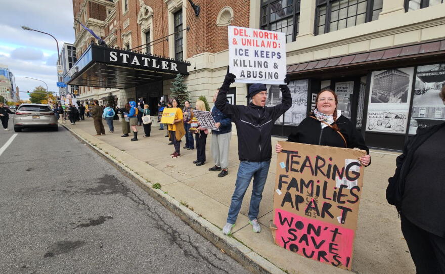 Protesters stand outside the Statler Building, calling for Carl Montante to end rental agreements with ICE