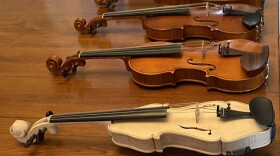 Violins made by luthier Tommy Case are lined up on his dining room table in his Georgetown home.