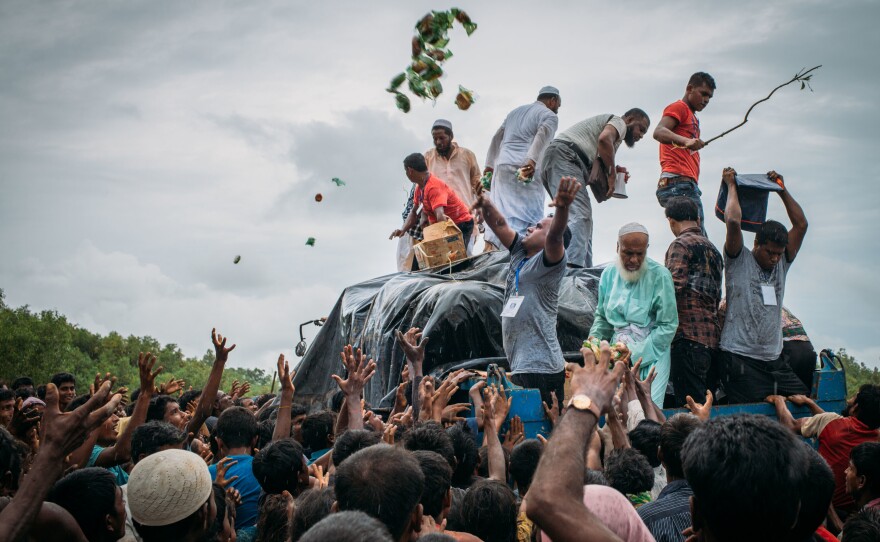 Bangladeshi volunteers distribute food donations to Rohingya Muslim refugees in Chittagong on Sunday. The United Nations warning of "ethnic cleansing" came as it emerged the Dalai Lama had written to Aung San Suu Kyi, urging Myanmar's de facto civilian leader to find a peaceful solution to the violence in the mainly Buddhist country.