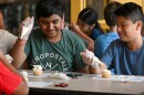 Harsh Patel and Fabian Lopez look at the icing on Patel's cupcake.