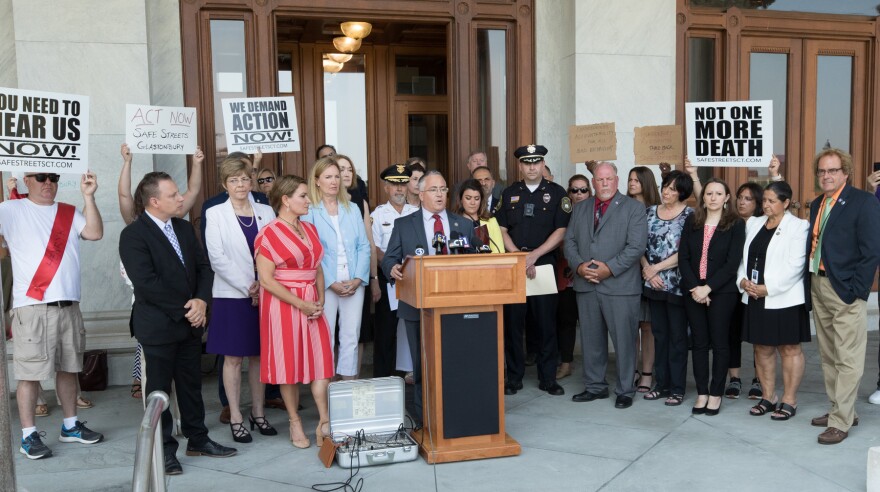 Republican state legislators and New Britain Mayor Erin Stewart and the city police chief during a press conference outside the state Capitol over the summer. The event happened shortly after the jogger was killed in New Britain by a stolen vehicle.