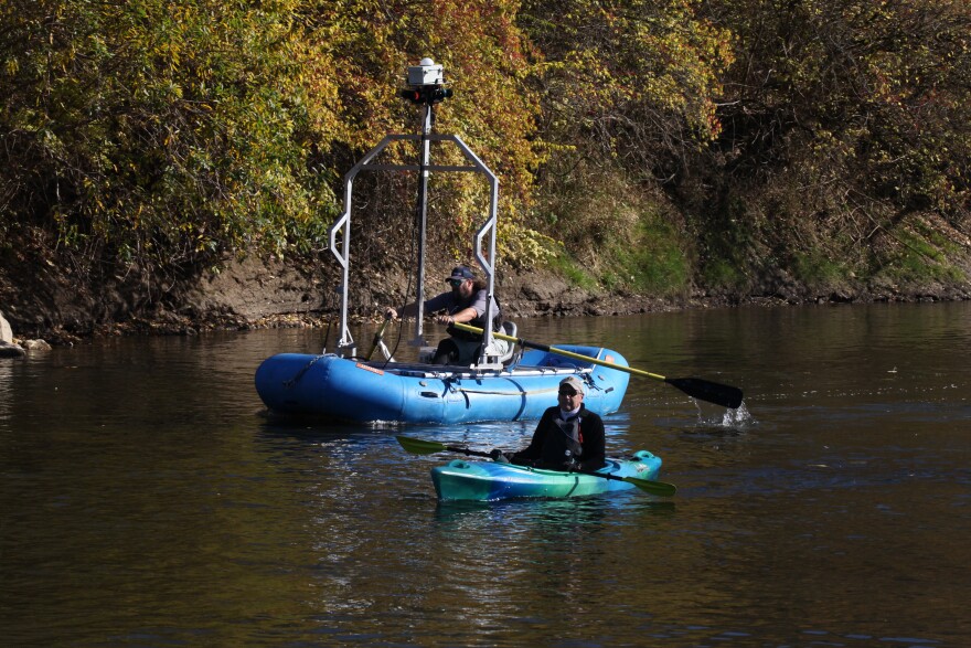 Terrain 360 Operator Ryan Crenshaw navigates a boat with cameras mounted to the top while Chief Research Officer Ben Fowler (right) guides Crenshaw in a kayak. The team sailed along the Cuyahoga River on Monday, November 13 to capture 360-degree images of the waterway that will be turned into Google Street View-style maps.