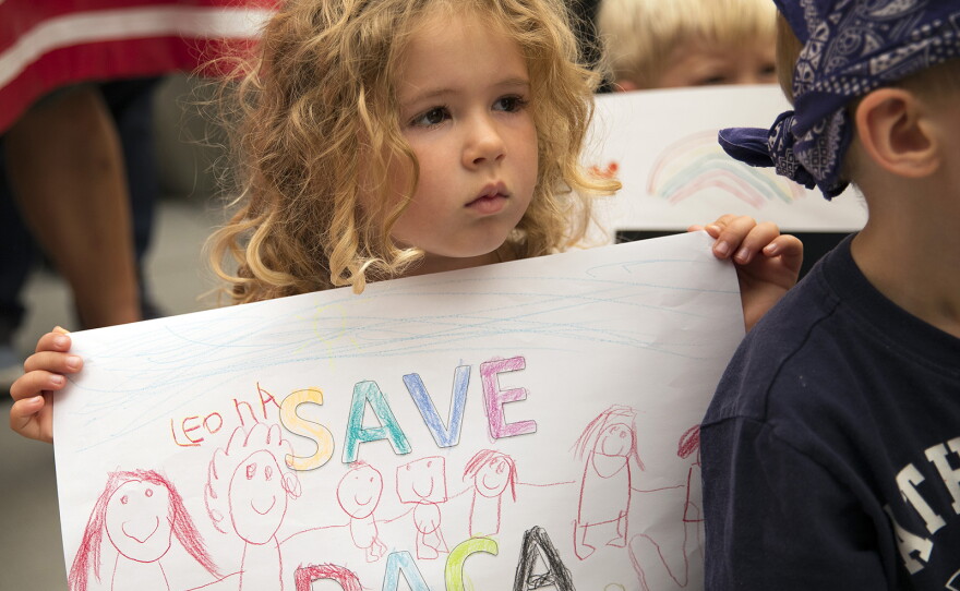 Leona, a student at the Jose Marti Child Development Center holds a Save DACA sign during a community rally in support of DACA recipients on Tuesday, September 5, 2017, at El Centro De La Raza in Seattle. 