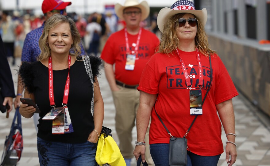 A Texas delegate, left, and guests walk outside of the Fiserv Forum during the Republican National Convention in Milwaukee, Wis., Tuesday, July 16, 2024.